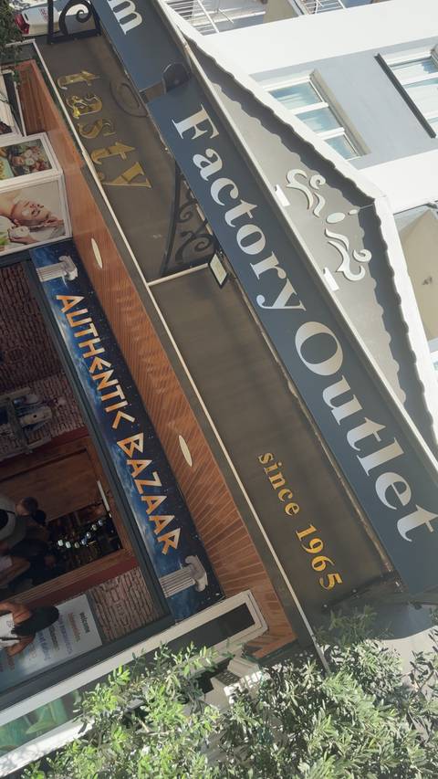 Shopping area with bazaar signage and structures.