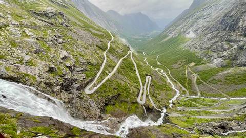 Steep winding road through mountainous landscape.