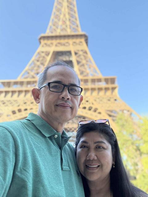       Selfie in front of the Eiffel Tower.
  