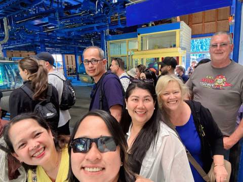       Group of tourists in a cable car station.
  