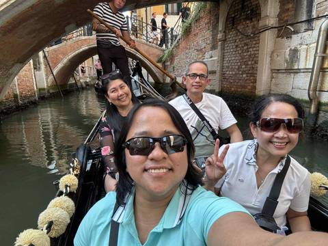       Group on a gondola ride in a canal.
  