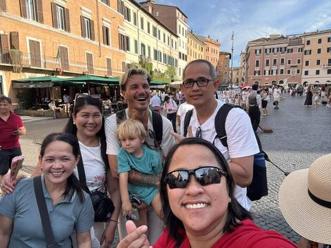 Group of tourists in a city square.