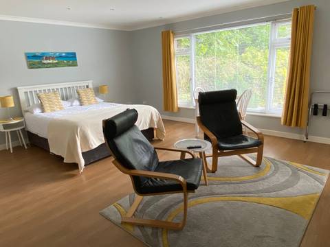 Modern interior of a room with chairs and a bed.