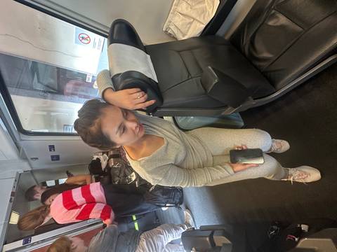 Person sitting tired on a train seat.