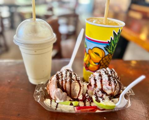       Close-up of two dessert items with drinks in the background.
  