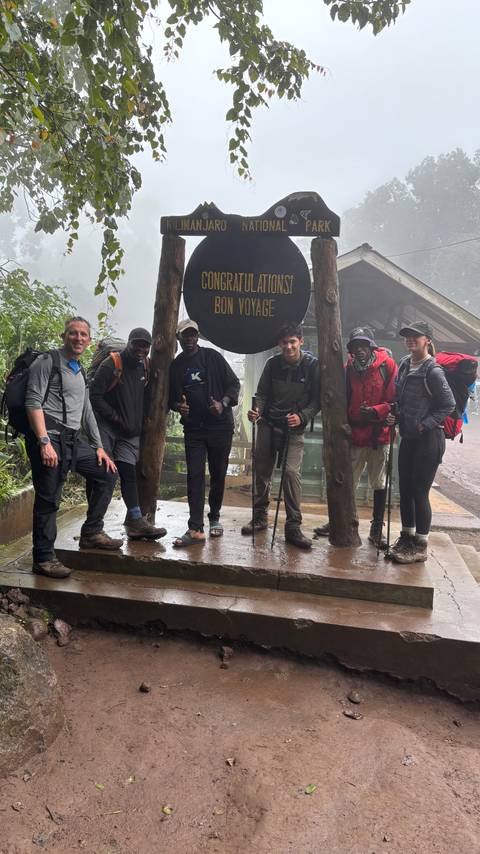       Group of hikers at a trailhead.
  