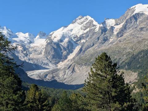       Snow-covered mountain range with clear blue skies.
  