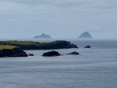 Offshore islands viewed from a coastal cliff with overcast skies.