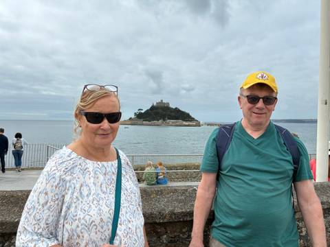 Couple posing with Saint Michael's Mount in the background.