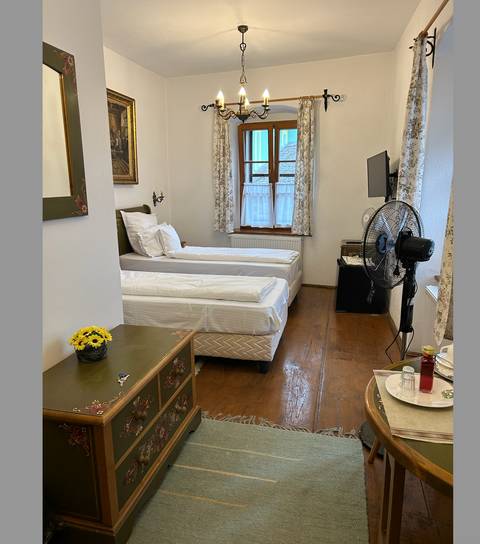       Simple hotel room with two single beds.
  