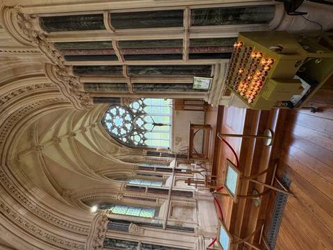       Interior of a historic church with candles.
  