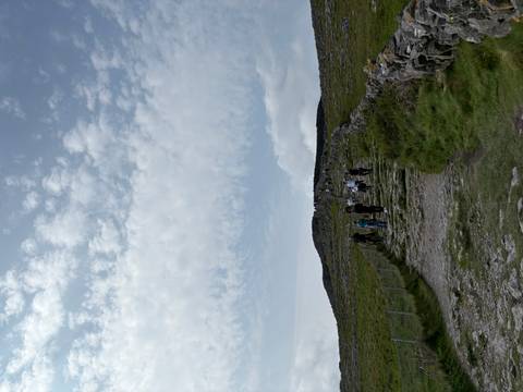       People hiking along a stone path.
  