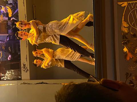       People dancing tango on a stage.
  