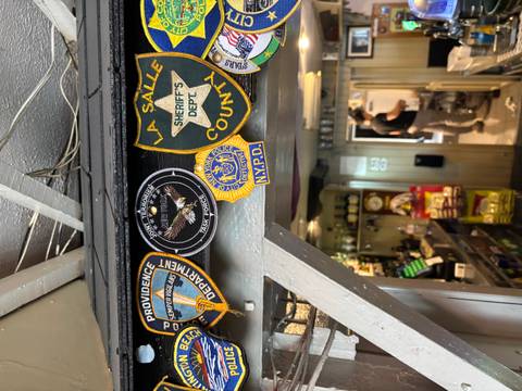       Interior with patches on the wall and a person in the background.
  