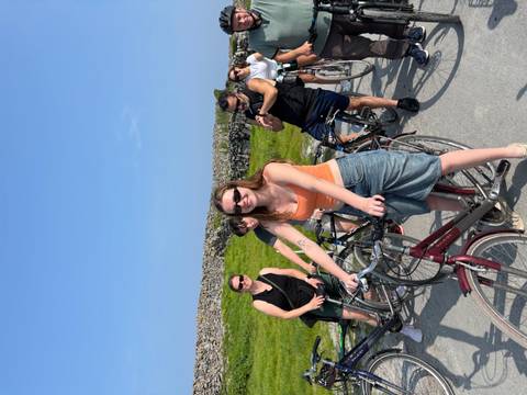       Group of people riding bicycles on a sunny day.
  