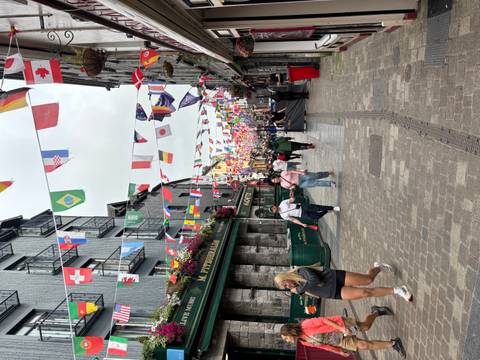       Colorful street decorated with international flags.
  