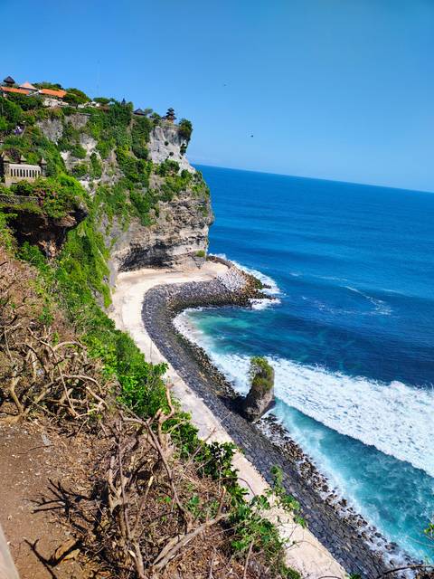 Ocean view with rocky cliffs and crashing waves.