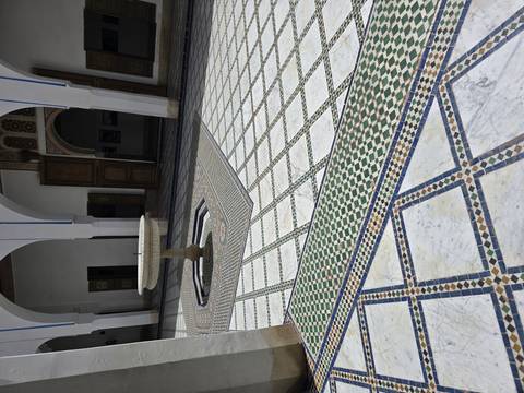 Tiled courtyard with a fountain in a palace.