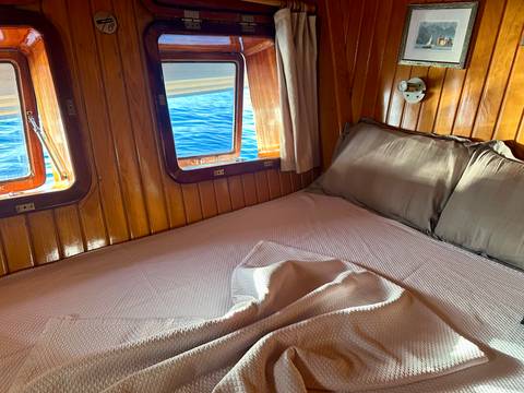 Cabin room with porthole windows and sea view.