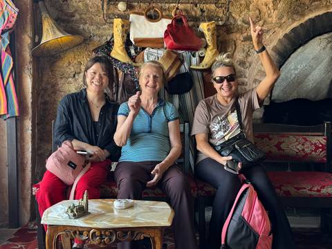 Two women and an older lady sitting in a cozy interior.