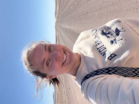 Person taking a selfie on a deserted road.