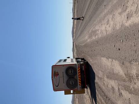 Safari truck parked on a desert road.