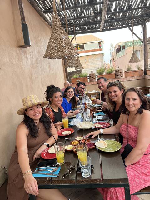       A group of people dining at an outdoor restaurant.
  