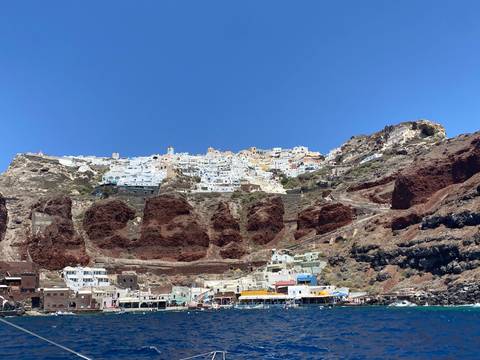A picturesque view of a cliffside village with whitewashed houses.