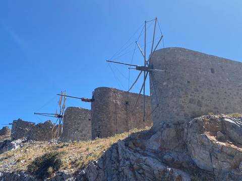 Historic windmills set against a blue sky.