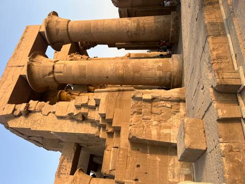 Ancient Egyptian temple with large columns and carvings.