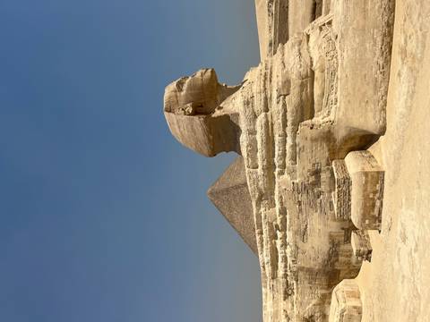       Great Sphinx of Giza with Pyramid in the background.
  