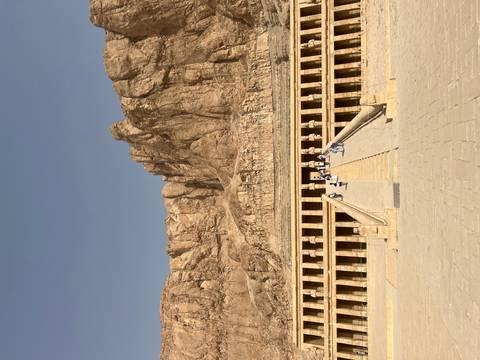       Mortuary Temple of Hatshepsut with tourists ascending the steps.
  