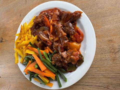 Plate of colorful mixed vegetables and meat.