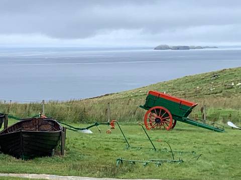       Colorful vintage cart on a hill overlooking the sea.
  