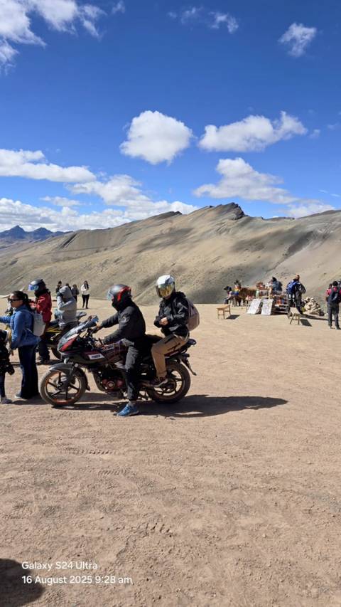       Tourists enjoying views at a mountainous viewpoint.
  