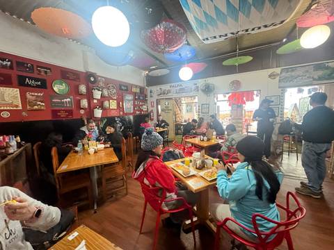       A bustling restaurant with patrons dining and chatting.
  