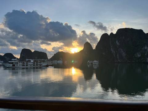 Cruise ships on Halong Bay during a scenic sunset.