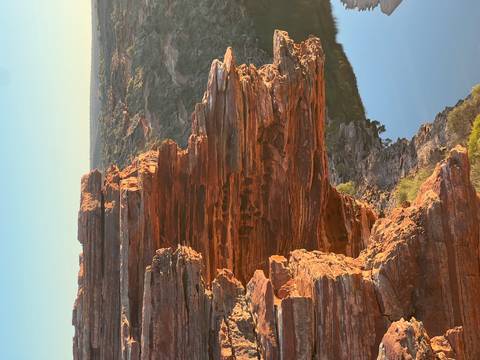 Red rock formation overlooking a river at sunset.