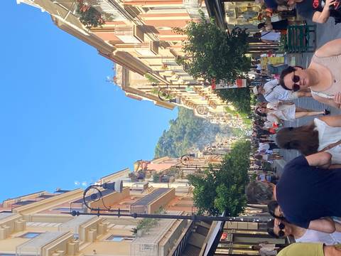 Street scene with people walking in a busy shopping area.