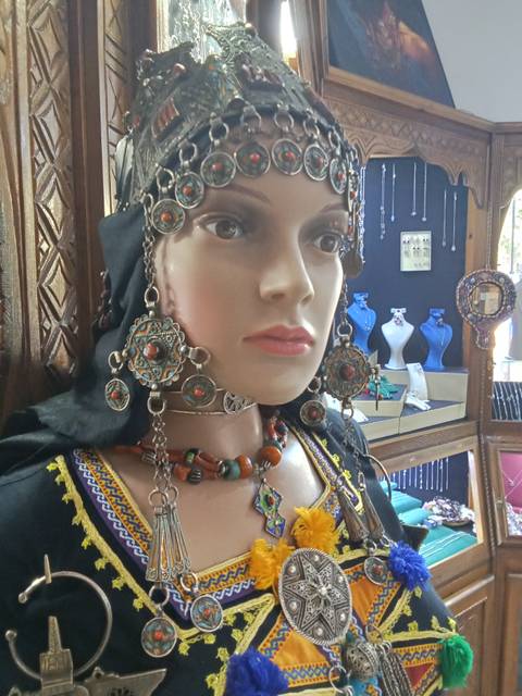 A mannequin wearing traditional Moroccan jewelry.
