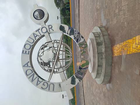       Uganda Equator monument with a globe sculpture.
  