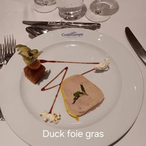 Gourmet dish on a white plate with a garnish.