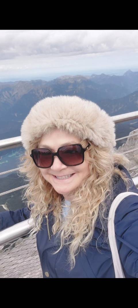 Close-up of a person smiling with a fur hat.