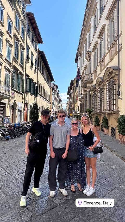 Family posing on a street lined with historical buildings.