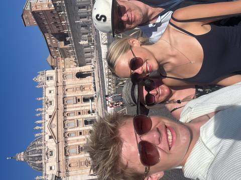 Family posing in front of St. Peter's Basilica.