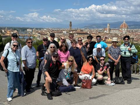       Large group of people with a view of Florence cityscape.
  