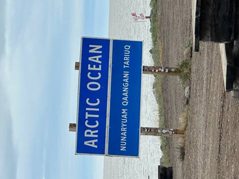       Arctic Ocean sign with a body of water in the background.
  