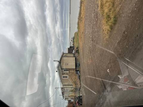       View of a house by a water body on an overcast day.
  