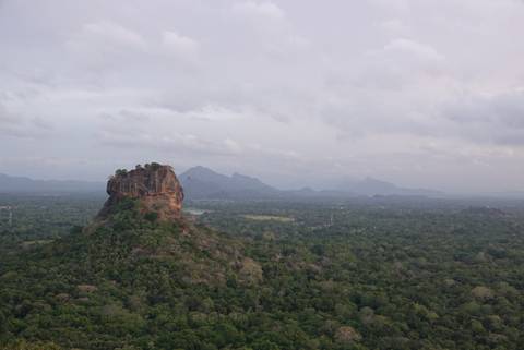 Aerial view of Sigiriya Rock amidst lush forest.