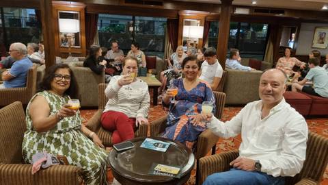 Group of people enjoying drinks in a cozy lounge.